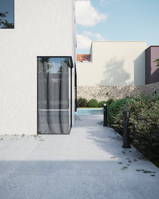 Elegant modern home exterior with garden, glass windows, and paved path.